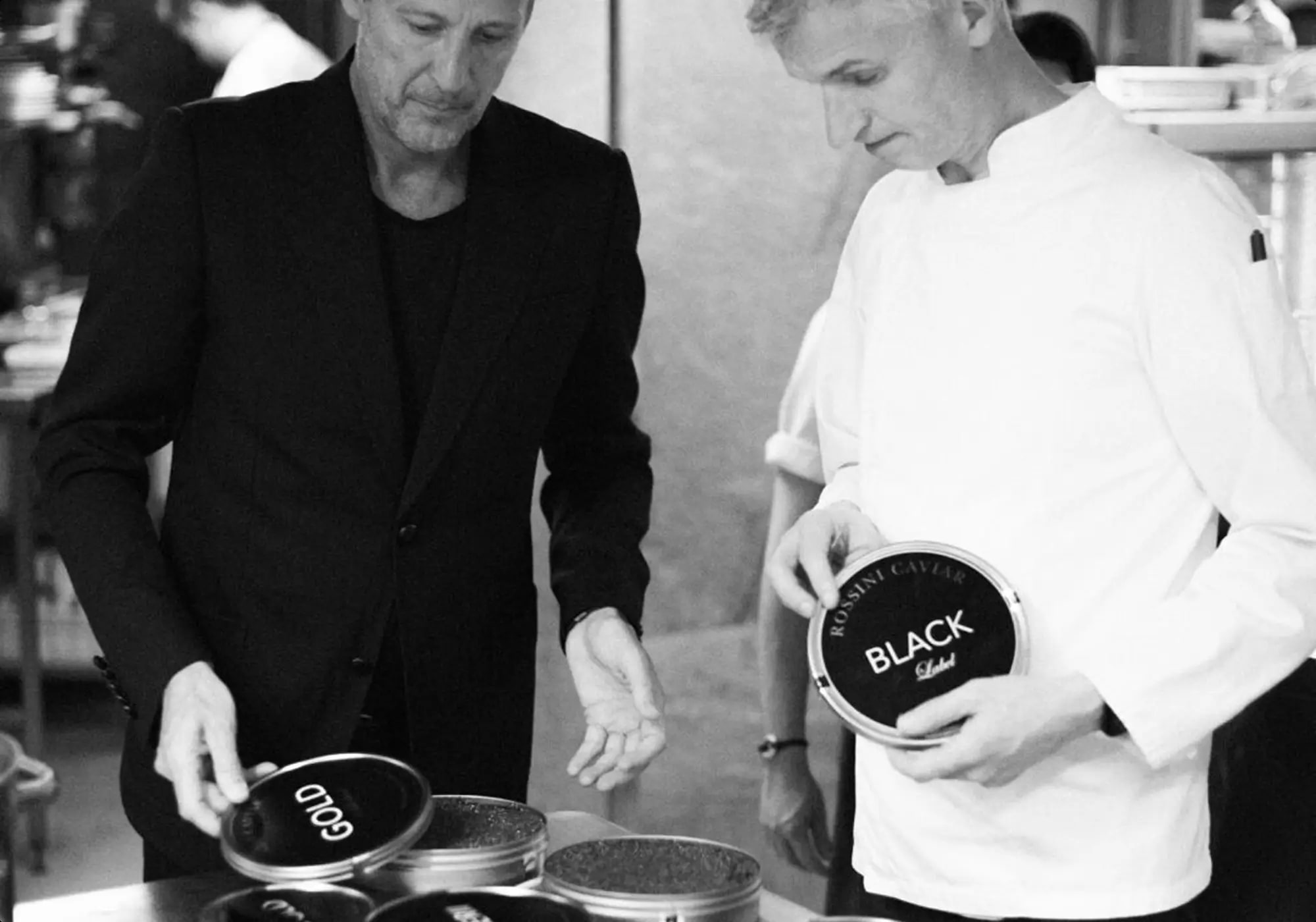Chefs evaluating open tins of caviar during selection